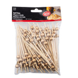 A clear plastic bag labeled Ball Picks contains 100 TableCraft 12583 bamboo ball picks, each topped with a small gold ball. The picks are 4.5 inches (11.5 cm) long, and the package features details in English, French, and Spanish.