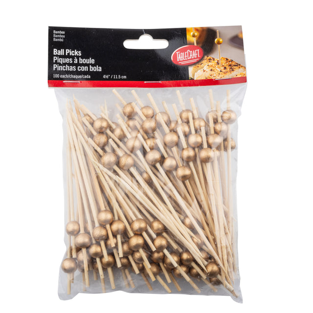 A clear plastic bag labeled Ball Picks contains 100 TableCraft 12583 bamboo ball picks, each topped with a small gold ball. The picks are 4.5 inches (11.5 cm) long, and the package features details in English, French, and Spanish.