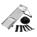 The TableCraft Mandoline Slicer Set features a stainless steel mandoline with an angled blade, foldable legs, a round black hand guard, and five interchangeable blade attachments for versatile slicing and julienning thicknesses.