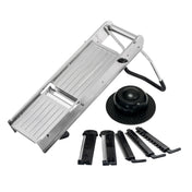 The TableCraft Mandoline Slicer Set features a stainless steel mandoline with an angled blade, foldable legs, a round black hand guard, and five interchangeable blade attachments for versatile slicing and julienning thicknesses.