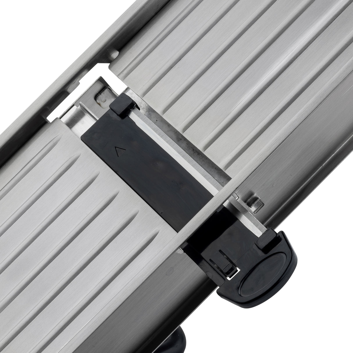Close-up of a stainless steel mandoline sliding mechanism with parallel grooves, featuring a black plastic locking component with a circular grip and arrow symbol, suggesting it is part of a Mandoline Slicer Set or adjustable equipment.