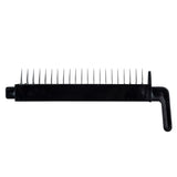 A black comb-like tool, resembling a TableCraft stainless steel mandoline, features long, evenly spaced metal tines projecting upward from its flat base with a handle on the right side, set against a white background.