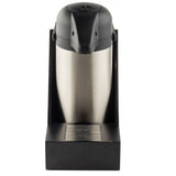 A stainless steel airpot coffee dispenser with a black lid sits in a matching black Single Airpot Rack featuring a stainless steel drip tray. The dispenser is centered and photographed against a white background, viewed from the front.