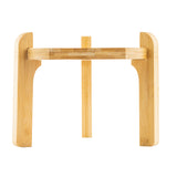 A minimalist and sturdy TableCraft bamboo stand features two vertical supports, a horizontal crossbar, and a central back support. Perfect as a book or beverage dispenser stand, it's photographed against a white background.