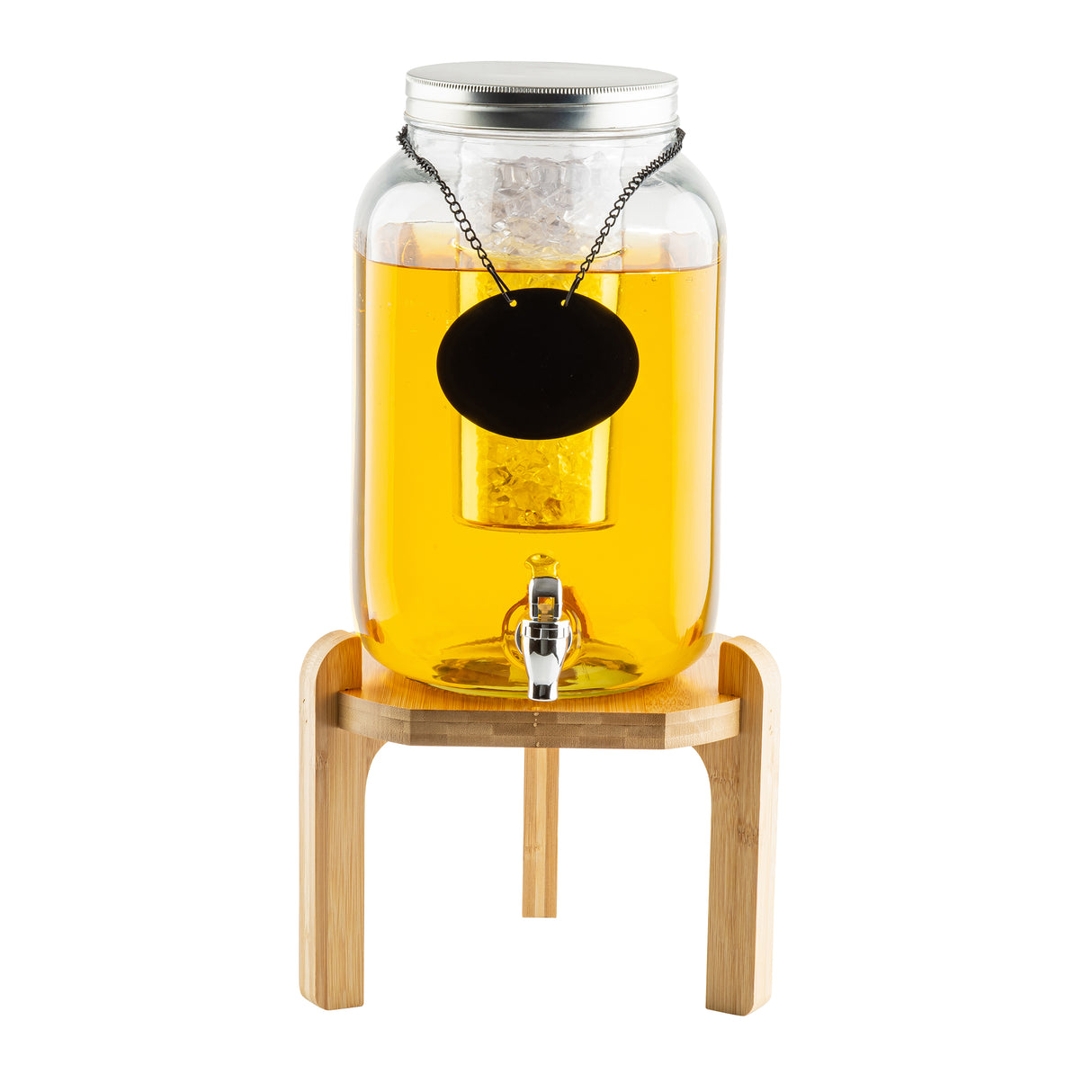A glass beverage dispenser filled with yellow liquid stands on a TableCraft 12652 glass beverage dispenser stand. It features a metal spigot, silver lid, cylindrical infuser, and a blank black hanging label. The background is white.