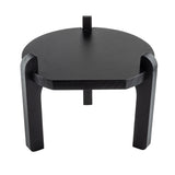 A modern, round, black painted wood stand with three thick, curved legs that extend above the tabletop for a bold, sculptural look. Perfect as a side table or TableCraft stand, it’s photographed against a white background.