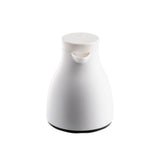 A white, modern, and minimalist 17 oz vacuum insulated coffee carafe with a curved body, a small spout at the top, and a flat round lid. The base is slightly wider and darker than the rest of the body. Set against a plain white background.