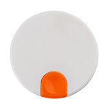 A round, flat white Decaf Lid with a smooth surface, featuring a small, glossy orange semi-circular section at the bottom edge—possibly a button or latch. The object is photographed from above on a plain white background.