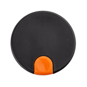A round, flat, black plastic object with a small, semi-circular orange tab at the bottom edge, photographed against a white background. The item appears to be a decaf lid for a coffee carafe, possibly from TableCraft.