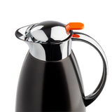 A matte black TableCraft coffee carafe with a shiny chrome lid and handle. The bright orange lever on the lid works as a spout opener. Its stainless steel surface reflects light, set against a plain white background.