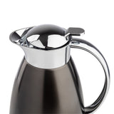 A close-up of a modern, 68 oz stainless steel coffee carafe with a shiny chrome lid and handle. The matte dark gray body contrasts with the reflective curved handle, while the lid features a convenient lever for easy pouring.