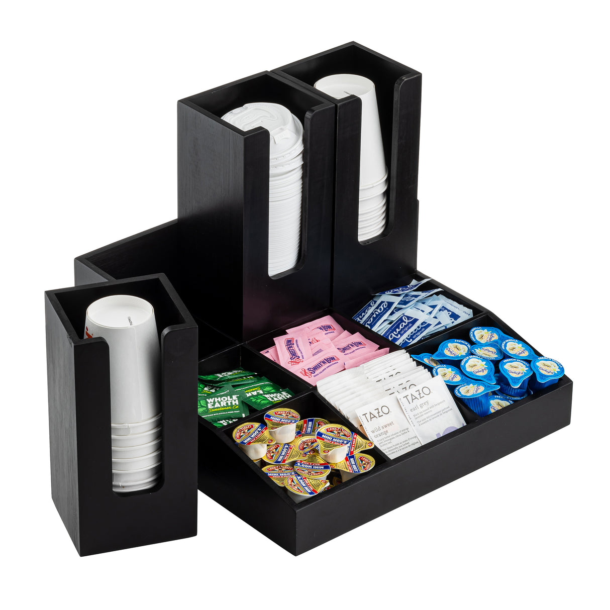 A black Coffee Condiment Organizer, crafted from painted bamboo, holds stacks of white cups, packets of sugar, sweeteners, creamers, and tea bags—all neatly arranged for a tidy coffee or tea station.