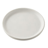 A plain, round, white serving plate from the Terra Collection is shown against a white background. The melamine surface has slightly raised edges and no decorations, with lighting that highlights its simple and clean design.