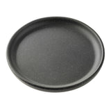 A round, gray speckled plate from the Terra Collection Serving Plate series sits on a white background. It features a slightly raised rim and a smooth, matte finish for an elegant touch.