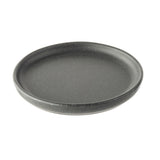 A round, dark gray speckled plate with a slightly raised rim and a matte, textured finish, shown on a white background. The plate appears empty and has a simple, modern design from the Terra Collection Serving Plate series.