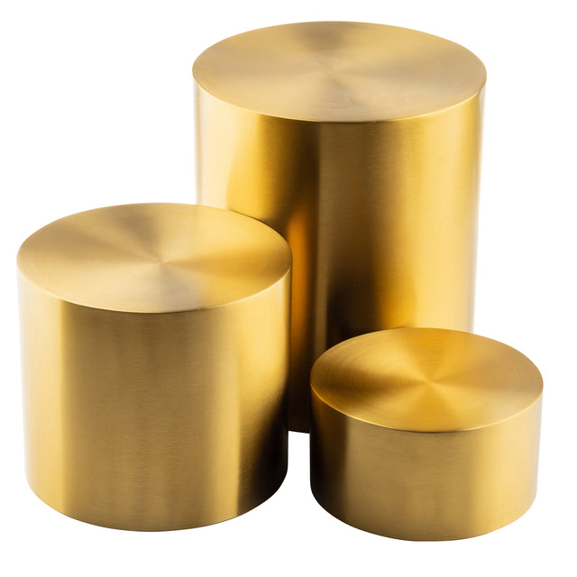 Three shiny, gold stainless steel cylinders of varying heights and diameters are arranged together on a white background. Each nesting riser set features a smooth, brushed finish with visible circular patterns on the flat tops.