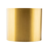 A cylindrical, metallic gold planter crafted from stainless steel with a smooth, brushed finish is shown against a plain white background. The planter has no visible seams, features clean lines, and pairs beautifully with any nesting riser set.