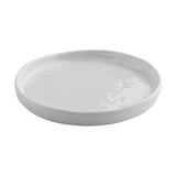 A plain, round, white Ridge Collection Serving Plate from TableCraft Products with a slightly raised rim, shown from an angled top view against a white background. The glossy melamine serving plate reflects light, giving it a smooth and clean appearance.