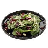 A black Melamine Serving Plate from the Ridge Collection holds fresh spinach leaves topped with crumbled feta cheese, dried cranberries, and whole pecans, all arranged neatly against a white background.