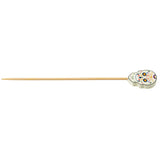 A bamboo pick with a decorative top shaped like a white Day of the Dead sugar skull, featuring colorful floral and swirl patterns. The decorative pick is light brown and pointed at one end.
