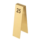 A gold, tent-shaped stainless steel table number stand with the number “25” printed in large, bold black letters on the front. This elegant Number Tent is photographed against a white background.