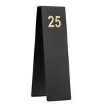 A black, triangular TableCraft Products table number stand with the number 25 in large metallic letters near the top. Made from powder coated stainless steel, this number tent is shown in side profile against a white background, highlighting its sturdy design.