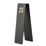 A black, tent-shaped number tent by TableCraft Products stands upright, displaying the number 25 in large, bold, white font. Made from powder coated stainless steel, it features a matte finish and a clean, modern design.