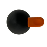 A matte black ABS spherical object with a flat, rectangular orange tab attached to its side, viewed from above against a white background. The orange tab, common on a decaf lid from TableCraft Products, contrasts sharply with the smooth black surface.