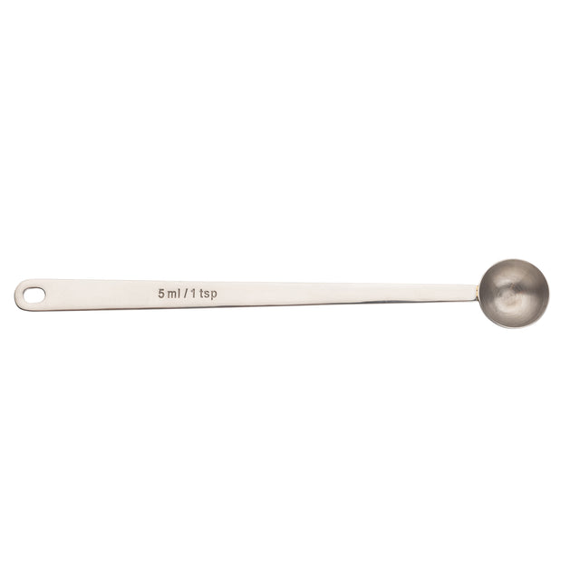 A stainless steel coffee scoop with a long handle and a round bowl. The handle is engraved with “5 ml / 1 tsp” and features a small hole at the end for hanging. The spoon is pictured on a white background.