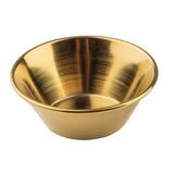 A small, round, metallic gold bowl with a wide rim and sloped sides, shown against a white background. This stainless steel ramekin features a shiny gold PVD finish that highlights its smooth, polished texture.