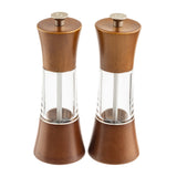 Two matching Salt & Pepper Mill Set grinders with an acacia finish and clear acrylic midsections stand upright side by side. Their modern hourglass design reveals the grinding mechanisms inside, topped with sleek silver accents.