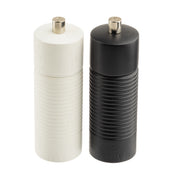 Two cylindrical grinders from the Salt & Pepper Mill Set stand side by side on a white background. The left has a smooth, textured white body; the right, a black ribbed finish. Both feature metallic knobs, reflecting classic TableCraft Products style.