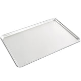 A shiny, full size heavy duty aluminum bun sheet pan with slightly raised edges rests on a white background. The surface is smooth and reflective, featuring neatly rounded corners with no visible markings or handles.