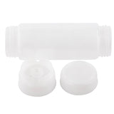 A translucent, empty plastic squeeze dispenser bottle is shown horizontally with its two separate white caps—one solid and one nozzle-style—placed in front. Both are designed to screw onto the bottle’s threaded neck, featuring the versatile Invertatop system.