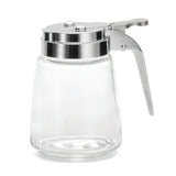 A modern glass dispenser with a wide base and chrome plated lid features a lever handle for easy pouring. The empty dispenser is set against a white background and is dishwasher safe for effortless cleaning.