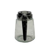 A Modern Glass Dispenser with a cylindrical shape, wide base, and shiny chrome plated lid. The metal lever handle and spout have a reflective finish. Dishwasher safe, this empty dispenser sits on a white background.