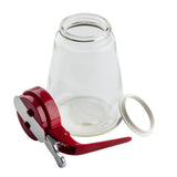 A clear glass dispenser jar is shown open and upside down. Next to it is a red and silver canning jar clamp tool, a white sealing ring, and all items are displayed on a white background. The set is dishwasher safe for easy cleaning.