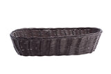 A dark brown, oval-shaped hand-woven basket is shown on a white background. Featuring an open weave pattern and a slightly raised, braided rim, this rustic and handcrafted-looking basket is empty.