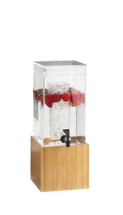 A clear rectangular beverage dispenser with a BPA Free design and a bamboo base holds water, floating strawberries, and ice in a central compartment. A black spigot is attached to the front for dispensing drinks. The background is plain white.