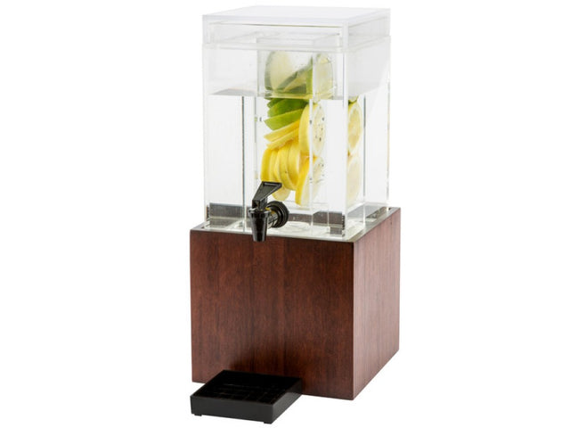 A square BPA free glass beverage dispenser filled with water and slices of lemon, lime, and cucumber sits on a wooden base. It features a black spigot for pouring, a drip tray beneath the spout, and a modern, elegant design.