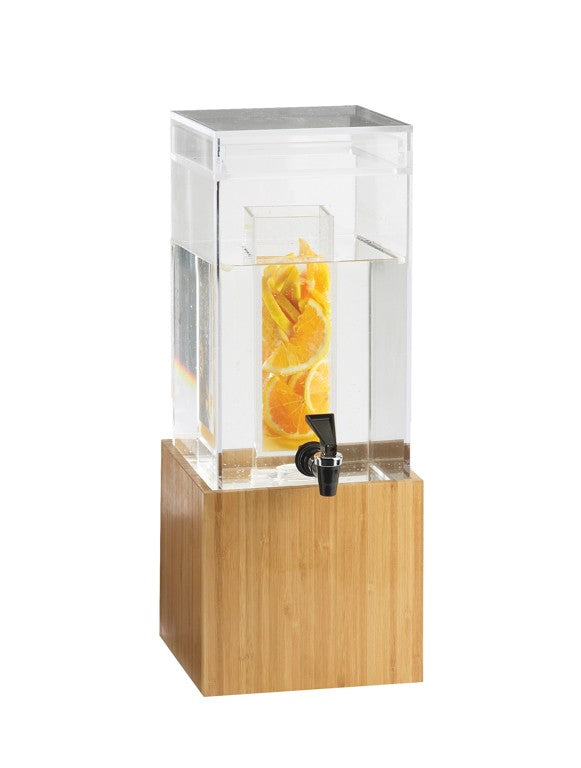 A BPA free beverage dispenser with a bamboo base, filled with water and orange slices in a central infusion chamber. It features a black spigot near the bottom for pouring, all set against a plain white background.