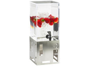 A clear, BPA free beverage dispenser with a central ice core is filled with water and whole strawberries. It stands on a modern stainless steel base with geometric cutouts and features a black spigot at the bottom front.