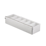 A rectangular stainless steel condiment holder with six white plastic compartments, viewed at an angle on a white background. Perfect for organizing garnishes or toppings, this versatile organizer is ideal for kitchens or bars.