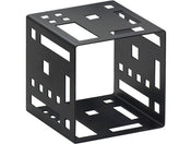 A black metal Squared Cube Riser with decorative geometric cutouts creates modern, abstract appeal. The hollow cube’s unique rectangular and square openings cast intriguing shadows against a clean white background.