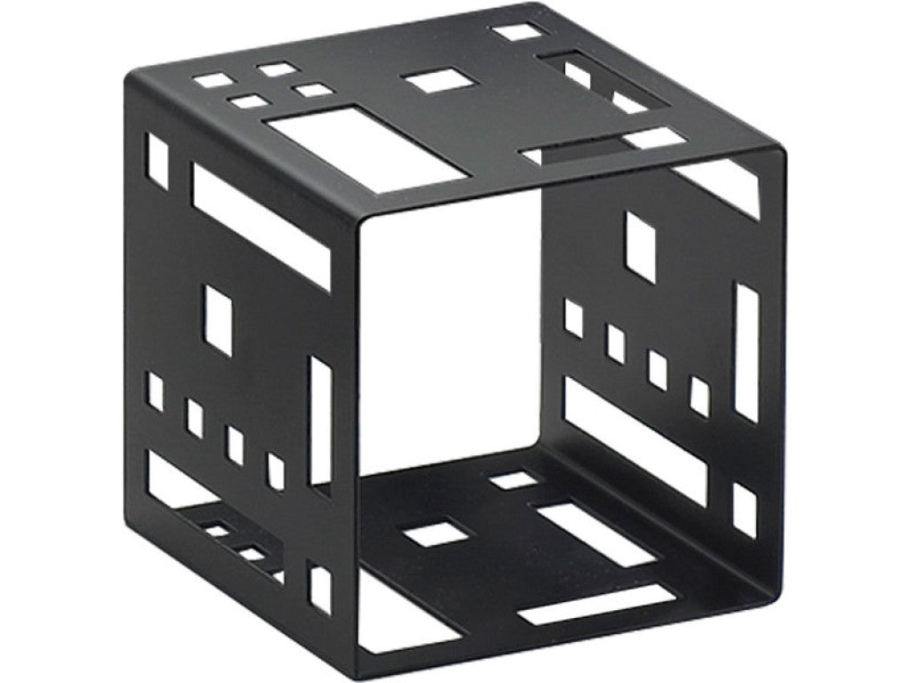 A black metal Squared Cube Riser with geometric cutouts features variously sized square and rectangular openings on all six sides, arranged in a grid-like pattern. The cube sits angled, revealing three faces with uniquely shaped cutouts.