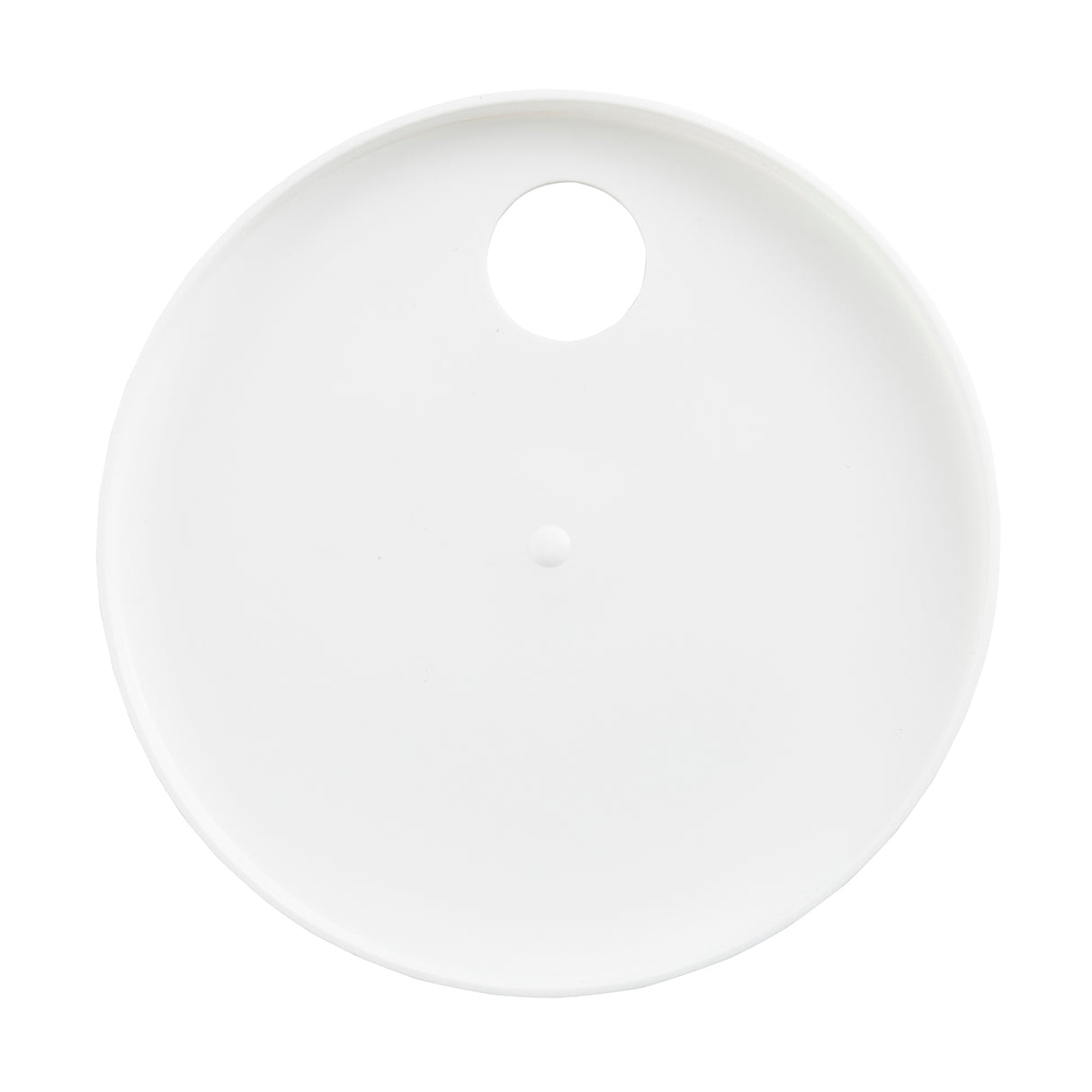 A round, flat white plate is shown from above. The plate, which is dishwasher safe, has a single large circular hole near the rim and a small raised bump in the center. The plain white background highlights its smooth surface and unique features.