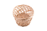 A round, empty, handwoven wicker basket with a crisscross pattern. The light brown basket is shown against a plain white background, with the open top facing upward and the intricate weaving visible.