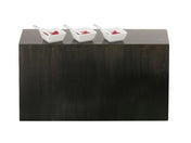 A dark Cal-Mil Midnight Bamboo Display Crate serves as a rectangular base against a white background. Three small white square dishes, each with a raspberry and white spoon, are spaced evenly on top in this minimalist, clean display riser scene.