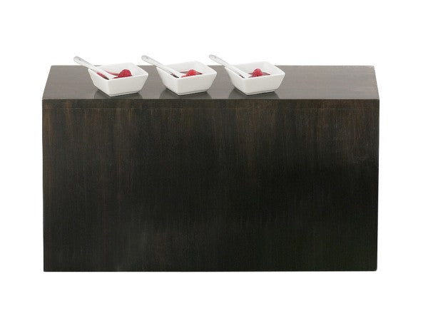 A dark Cal-Mil Midnight Bamboo Display Crate serves as a rectangular base against a white background. Three small white square dishes, each with a raspberry and white spoon, are spaced evenly on top in this minimalist, clean display riser scene.