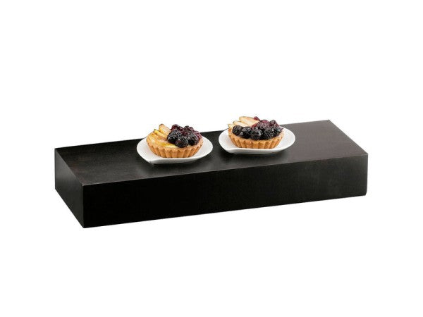 A black rectangular display riser holds two white plates, each with a fruit tart topped with blueberries and thin slices of fruit, arranged side by side, against a plain white background.